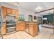 Charming kitchen featuring tile floors, granite countertops, and stainless steel appliances at 2 E Kelly Park Rd, Apopka, FL 32712