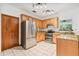 Bright kitchen with stainless steel refrigerator and double oven with granite countertops at 2 E Kelly Park Rd, Apopka, FL 32712