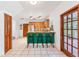 Eat-in kitchen featuring wood cabinets, bar stool seating and a door that leads to the outdoors at 2 E Kelly Park Rd, Apopka, FL 32712