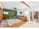 Living room area with hardwood floors, decorative wall art, and access to the next room at 2 E Kelly Park Rd, Apopka, FL 32712
