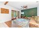 Living room showcasing a designer accent wall, wooden beams, and access to the porch at 2 E Kelly Park Rd, Apopka, FL 32712