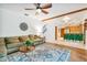 Spacious living room with wood beam, large rug, and staircase at 2 E Kelly Park Rd, Apopka, FL 32712