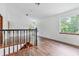 Spacious loft area with wood floors, large windows, and natural light, perfect for relaxing or entertaining at 2 E Kelly Park Rd, Apopka, FL 32712