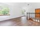 Bright loft area with wood floors and multiple windows offering plenty of natural light and scenic views at 2 E Kelly Park Rd, Apopka, FL 32712