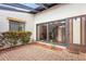 Charming courtyard featuring brick flooring, lush foliage, and a glass-paneled front door at 2080 Roseway Ave, Deltona, FL 32738