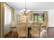 Elegant dining room with marble table, rattan chairs, and chandelier, perfect for entertaining guests at 2080 Roseway Ave, Deltona, FL 32738