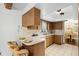 Eat-in kitchen with wood cabinets, a breakfast bar, and a view into the adjacent dining room at 2080 Roseway Ave, Deltona, FL 32738