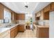 Bright kitchen leading to dining area, featuring classic wood cabinetry and practical layout for everyday living at 2080 Roseway Ave, Deltona, FL 32738