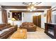 Cozy living room features exposed beams, a decorative fireplace, and comfortable seating for relaxation at 2080 Roseway Ave, Deltona, FL 32738