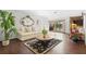 Bright living room features wood floors, an ornate mirror, and patio access at 2080 Roseway Ave, Deltona, FL 32738