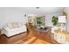 Sunlit living room featuring wood flooring and a view of the adjacent dining area at 2080 Roseway Ave, Deltona, FL 32738