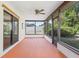 Spacious enclosed patio with tile flooring and views of the landscaped yard at 2080 Roseway Ave, Deltona, FL 32738