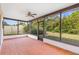 Relaxing screened patio with a ceiling fan and views of the backyard at 2080 Roseway Ave, Deltona, FL 32738