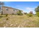 A spacious backyard showing the home's exterior, providing ample space for outdoor activities and landscaping at 2234 N Normandy Blvd, Deltona, FL 32725