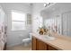 Well-lit bathroom with a vanity, white fixtures, floral shower curtain, and tiled flooring at 2234 N Normandy Blvd, Deltona, FL 32725