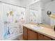 Bathroom showcasing a vanity with a sink, a decorative Paris-themed shower curtain, and tiled flooring at 2234 N Normandy Blvd, Deltona, FL 32725