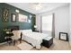 Well-lit bedroom with a neutral palette, a ceiling fan, and a dedicated desk space for work or study at 2234 N Normandy Blvd, Deltona, FL 32725