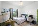 Inviting bedroom with a twin bed, desk area, natural light, and charming decor with carpet flooring at 2234 N Normandy Blvd, Deltona, FL 32725