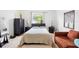 Cozy bedroom featuring a queen bed, dark wood furniture, and a comfortable seating area with carpet flooring at 2234 N Normandy Blvd, Deltona, FL 32725