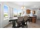 Dining area featuring large windows, a dark wood dining table with upholstered chairs, and natural lighting at 2234 N Normandy Blvd, Deltona, FL 32725