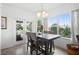 Bright dining area with backyard views, a modern table with seating for four, and neutral walls at 2234 N Normandy Blvd, Deltona, FL 32725