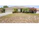 Beautifully landscaped front yard with mature trees, colorful flowers, and a cozy single-story home at 2234 N Normandy Blvd, Deltona, FL 32725