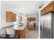 Open kitchen featuring an island, stainless steel appliances, wooden cabinets, and eat-in breakfast bar at 2234 N Normandy Blvd, Deltona, FL 32725