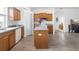 Charming kitchen featuring wooden cabinets, an island, and modern appliances on light gray toned flooring at 2234 N Normandy Blvd, Deltona, FL 32725