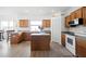 Spacious kitchen featuring an island, modern appliances, ample counter space, and light hardwood floors at 2234 N Normandy Blvd, Deltona, FL 32725
