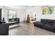 Inviting living room with hardwood floors, white walls, and an open view to the bedroom at 2234 N Normandy Blvd, Deltona, FL 32725