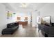 Bright living room with hardwood floors and an open-concept design, seamlessly flowing into the kitchen at 2234 N Normandy Blvd, Deltona, FL 32725
