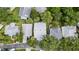 An aerial view of homes with well-maintained roofs surrounded by lush green trees in a residential neighborhood at 232 River Village Dr, Debary, FL 32713