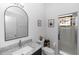 Bright bathroom featuring a granite countertop vanity and glass-enclosed shower with decorative stained-glass window at 232 River Village Dr, Debary, FL 32713