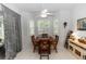 Cozy dining area featuring a wood table set beneath a ceiling fan and brightened by natural light at 232 River Village Dr, Debary, FL 32713