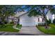 Charming home with a well-maintained yard, white siding, attached garage and an inviting front porch at 232 River Village Dr, Debary, FL 32713