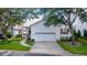 Charming home with a well-maintained yard, white siding, attached garage and an inviting front porch at 232 River Village Dr, Debary, FL 32713