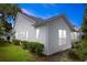 Home exterior showcasing well-maintained siding, lush landscaping, and a manicured lawn under a beautiful sky at 232 River Village Dr, Debary, FL 32713
