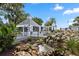 A beautiful community recreation area with a waterfall and lounge area surrounded by lush landscaping at 232 River Village Dr, Debary, FL 32713