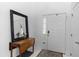 Clean, bright foyer featuring a side table, a decorative mirror, and a neutral-toned rug at 232 River Village Dr, Debary, FL 32713