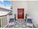 Welcoming front porch with seating, decorative rug, vibrant door, and pleasant curb appeal at 232 River Village Dr, Debary, FL 32713