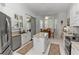 Bright kitchen featuring white cabinetry, granite countertops, stainless steel appliances, and a cozy breakfast nook at 232 River Village Dr, Debary, FL 32713