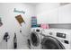 Well-equipped laundry room with side-by-side washer and dryer, white cabinets, and ample storage space at 232 River Village Dr, Debary, FL 32713