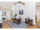 Spacious office living room featuring light hard wood floors, and a decorative blue area rug at 232 River Village Dr, Debary, FL 32713