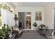 Cozy screened patio featuring comfortable seating, decorative plants, and a view of the backyard at 232 River Village Dr, Debary, FL 32713