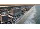 Aerial view of beachfront condo building with pools and beach access at 2403 S Atlantic Ave # 410, Daytona Beach, FL 32118