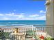 Charming balcony with cozy seating, offering panoramic ocean views and a serene spot to unwind and enjoy coastal living at 2403 S Atlantic Ave # 410, Daytona Beach, FL 32118