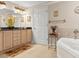 Elegant bathroom with a tub and black countertops on wood cabinetry at 2403 S Atlantic Ave # 410, Daytona Beach, FL 32118