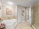 Bright bathroom showcasing a garden tub and glass shower at 2403 S Atlantic Ave # 410, Daytona Beach, FL 32118