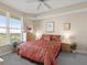 An airy bedroom features large windows, tropical bedding, and natural light for a serene space at 2403 S Atlantic Ave # 410, Daytona Beach, FL 32118