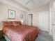 Bright bedroom featuring tropical themed bedding and a ceiling fan at 2403 S Atlantic Ave # 410, Daytona Beach, FL 32118